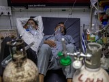 Số bệnh nhân liên tục gia tăng đã khiến nguồn lực y tế cạn kiệt. Trong ảnh: 2 bệnh nhân COVID-19 nằm chung một giường trong một bệnh viện ở Delhi (Ảnh: Reuters).