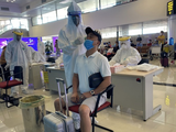 Nhân viên y tế lấy mẫu xét nghiệm COVID-19 cho người dân tại sân bay (Ảnh - BYT)