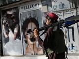 Những tấm poster có hình phụ nữ bị bôi xóa phần mặt (Ảnh: AFP)