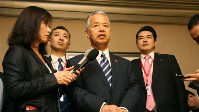 Bộ trưởng Kinh tế Nhật Akira Amari thông báo kết quả đàm phán. Ảnh: AFP