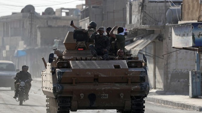 Các chiến binh nổi dậy Syria do Thổ Nhĩ Kỳ hậu thuẫn trên một chiếc xe quân sự ở thị trấn Tal Abyad, Syria (Ảnh: Reuters)