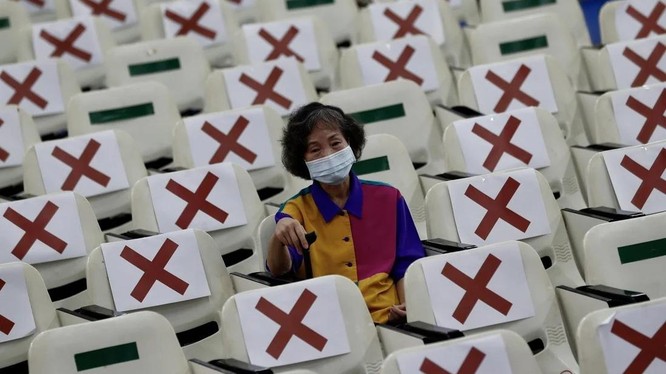 Một người dân ở Đài Loan ngồi chờ 15 phút sau khi được tiêm vaccine COVID-19 (Ảnh: EPA)