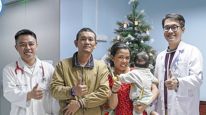 Bố và mẹ bé K.N, cùng bác sĩ điều trị trong niềm vui trước ngày ra viện