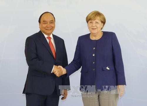 Thủ tướng Nguyễn Xuân Phúc và Thủ tướng Angela Merkel - Ảnh: TTXVN