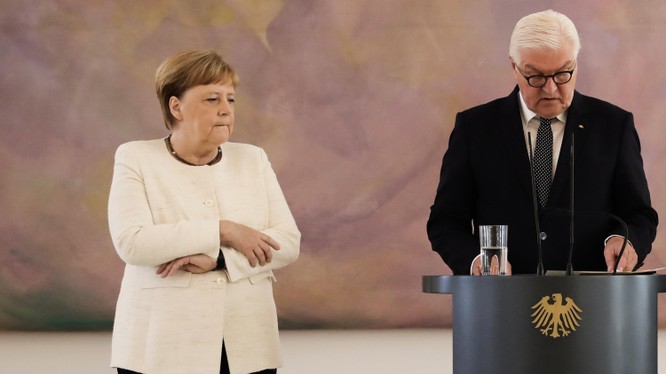 Thủ tướng Merkel giữ chặt hai tay trong cơn run lẩy bẩy (Ảnh: Telegraph)