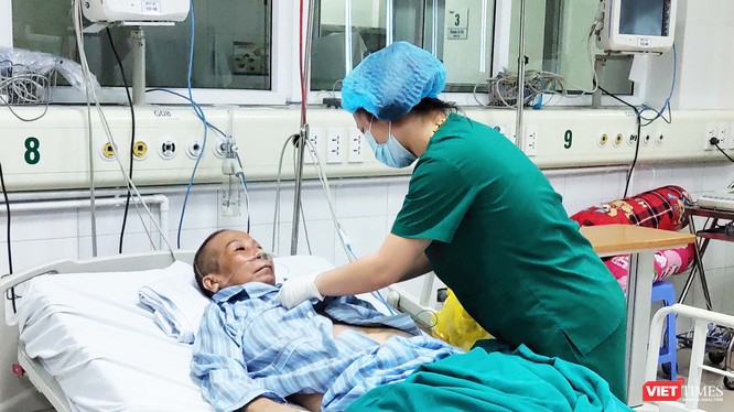 Bác sĩ chăm sóc cho bác gái bệnh nhân 17 mắc COVID-19 nặng. Ảnh: Minh Thúy 