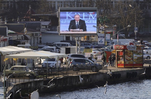 A screen, showing Russian President VladimirPutin's annual end-of-year news conference, is on display on an embankment of the Black Sea port of Sevastopol, Crimea, December 17, 2015. REUTERS/Pavel Rebrov