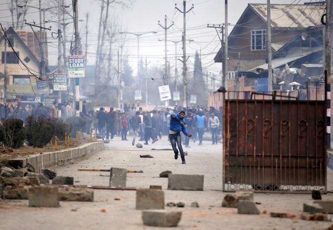 Một người biểu tình Kashmiri ném một hòn đá về phía cảnh sát Ấn Độ trong một cuộc biểu tình ở Srinagar ngày 14/1. Hàng trăm người xuống đường biểu tình sau khi thi thể một thanh niên được cho là mất tích đã được tìm thấy gần đường sắt.