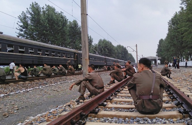 Korean People's Army soldiers rested on the tracks.