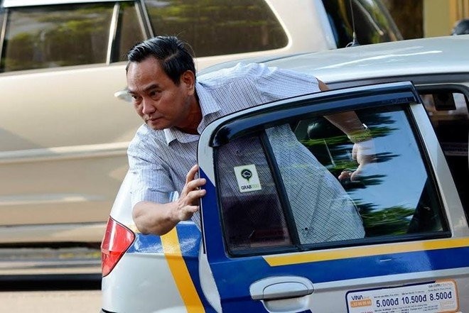 Thứ trưởng Nguyễn Hữu Chí bước xuống từ taxi.