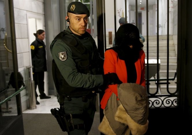 Cảnh sát Tây Ban Nha giải một nghi can khỏi văn phòng Ngân hàng ICBC của Trung Quốc tại Madrid trong đợt lục soát ngày 17-8 - Ảnh: Reuters