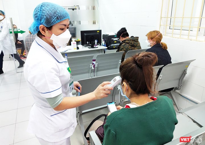 Bác sĩ kiểm tra thân nhiệt cho bệnh nhân tại Bệnh viện Bạch Mai. Ảnh: Minh Thúy 