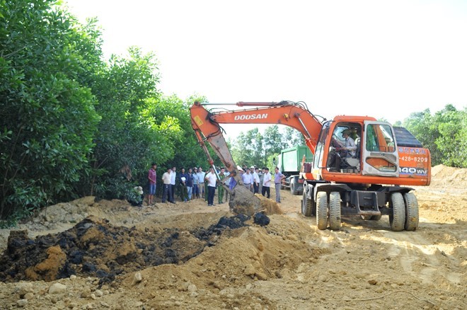 Lực lượng chức năng đã huy động 2 chiếc máy xúc đào bới 100 tấn chất thải của Formosa chôn lấp trái phép tại trang trại ở phường Kỳ Trinh đưa về nơi quy định. Ảnh: Xuân Đức.