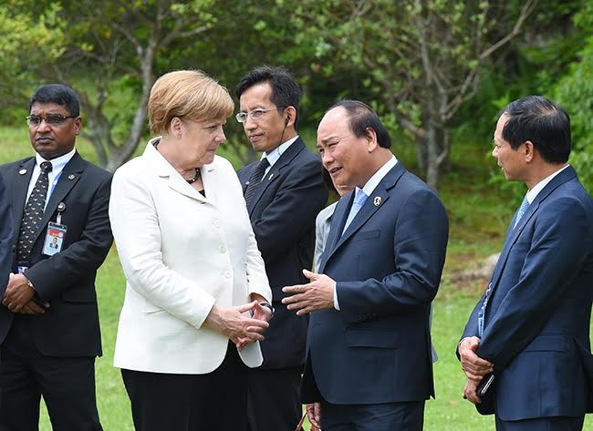 Thủ tướng Việt Nam và Thủ tướng Đức trao đổi bên lề hội nghị.