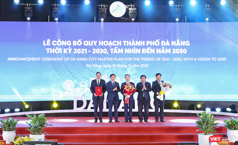 Phó Thủ tướng Chính phủ Trần Hồng Hà (thứ hai từ trái qua) và Bộ trưởng Bộ KH&ĐT Nguyễn Chí Dũng (thứ hai từ phải qua) trao quyết định phê duyệt của Chính phủ Quy hoạch TP Đà Nẵng thời kỳ 2021 - 2030, tầm nhìn đến năm 2050 của Chính phủ cho lãnh đạo TP Đà Nẵng