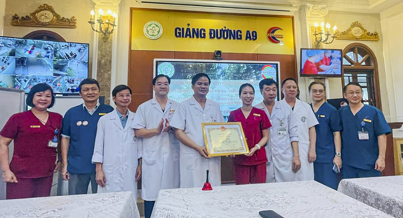 PGS.TS Đào Xuân Cơ, Giám đốc Bệnh viện Bạch Mai, trao giấy khen và thưởng "nóng" nữ điều dưỡng Đặng Thị Hạ. (ảnh Thái Bình).