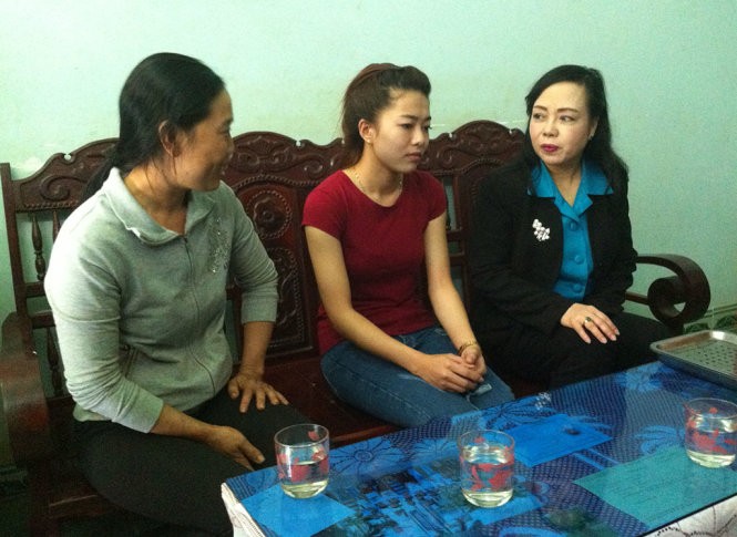 Bộ trưởng Nguyễn Thị Kim Tiến (bìa phải) thăm hỏi đại diện gia đình em Vi - Ảnh: Hà Bình