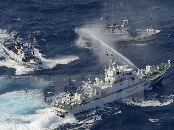 Tàu bảo vệ bờ biển Nhật Bản (phải) phun nước vào các thuyền của Đài Loan tại vùng biển Hoa Đông. (Nguồn: AFP/TTXVN)