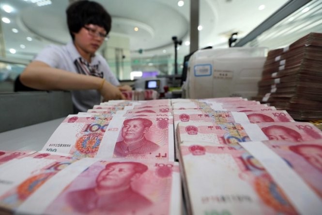 Đồng NDT giảm giá có thể dẫn tới chiến tranh tiền tệ Ảnh: AFP