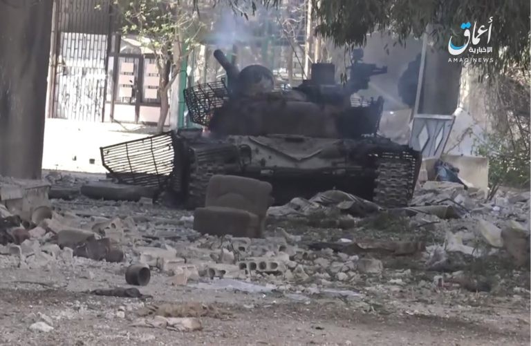 Một xe tăng quân đội Syria, được cho là bị IS bắn cháy ở khu vực trại tị nạn Yarrmouk, Damascus - ảnh trang Amaq