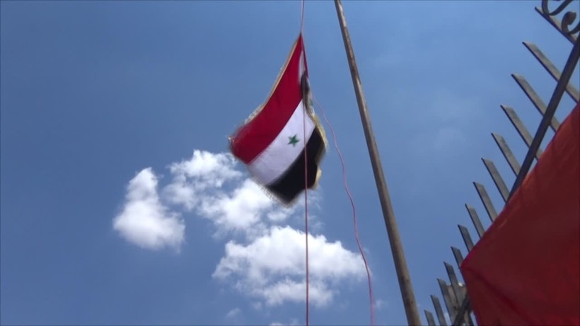 Người dân thị trấn Al-Moseifera tỉnh Daraa thượng cờ Syria ở Daraa. Ảnh minh họa Masdar News