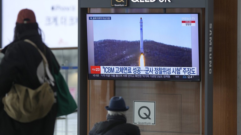 Người dân Triều Tiên quan sát vụ phóng tên lửa trên TV. Ảnh RT