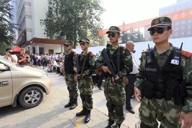 Cảnh sát Trung Quốc canh gác bên ngoài một trường trung học trong kì thi Đại học Quốc gia tại Trịnh Châu, tỉnh Hà Nam vào ngày 7/6/2014 (ảnh: Ibtimes)