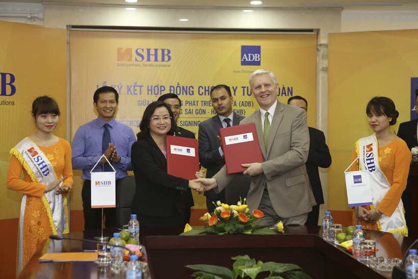  Bà Ngô Thu Hà (trái) – Phó Tổng Giám đốc SHB và ông Eric Sidgwick – Giám đốc quốc gia đại diện thường trú ADB tại Việt Nam thực hiện nghi lễ ký kết. (Ảnh: SHB)