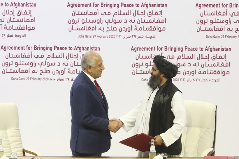 Trưởng đoàn đàm phán của Mỹ, ông Zalmay Khalilzad (trái) và trưởng đoàn đàm phán của Taliban Mullah Abdul Ghani Baradar trong lễ ký thỏa thuận ở Doha (Ảnh: Politico)